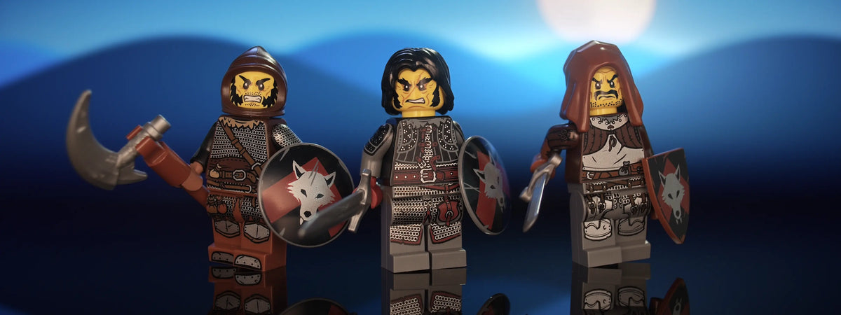 Hero shot of three of Castle Clad Bricks custom pad printed bandit minifigures with accessories, set 3 of 4 — armored figures with shields, night scene, panorama