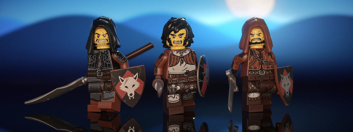 Hero shot of three of Castle Clad Bricks custom pad printed bandit minifigures with accessories, set 2 of 4 — armored figures with shields, night scene, panorama