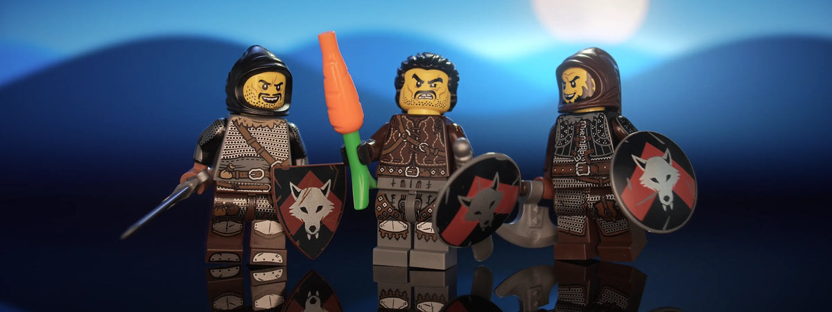 Hero shot of three of Castle Clad Bricks custom pad printed bandit minifigures with accessories, set 4 of 4 — armored figures with shields, night scene, panorama